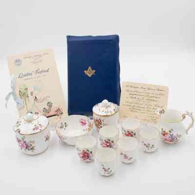 Masonic Presentation Bible and accompanying China.: Image of the blue Masonic presentation Bible and accompanying Royal Crown Derby porcelain: 1 pitcher, 1 jam pot, 1 sugar bowl, 1 small bowl, 6 demitasse cups w/out handles. All of the porcelain is bone China with a floral posies design. There is also the invitation from the event, the "Ladies' Festival," and the program from the event.