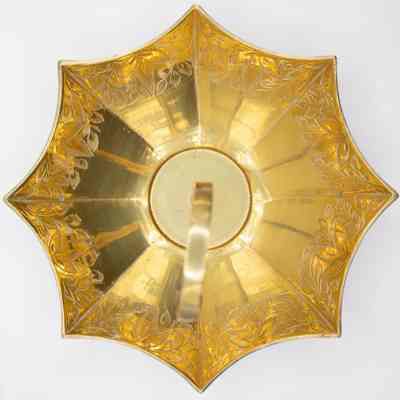 Birds eye view of umbrella dish: A golden umbrella dish viewed from above, features ornate floral patterns.