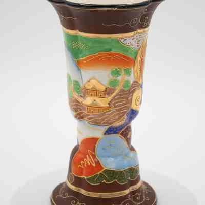 Back of the painted Japanese porcelain vase.: Image of the back of the painted Japanese porcelain vase. It is decorated with brown, green, orange, and blue paint and depicts mountain and temple scene. The vase has a faux cloisonne look with raised gold paint.