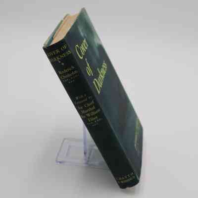 Book Spine: The spine of “Cover of Darkness” features the book title, author, and publisher.