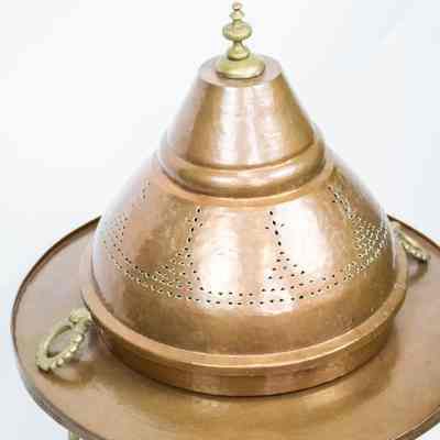 Large brazier: The image features a large, intricately designed copper brazier with a domed cover, complete with pierced details and decorative handles on each side.
