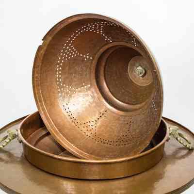 Large brazier: The image displays a large copper brazier with a domed cover featuring decorative perforations, resting on a sturdy copper base with two ornate handles.