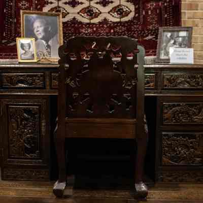 Wooden desk and chair: A carved wooden desk and chair, adorned with intricate Hong Kong motifs, exhibit elegant craftsmanship and traditional artistry