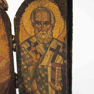 Right door of triptych: Close up image of the right door of the triptych. In the door is a Byzantine-style painting of St. Peter. He has a cruciform halo. The painting is cracked and darkened.