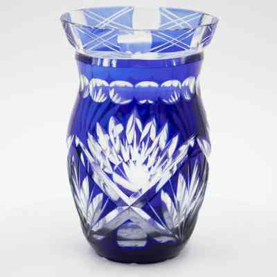 Small blue and clear cut crystal vase.: Up close image of the small blue and clear cut crystal vase decorated in a geometric Bohemian Czech-style with cobalt detail.