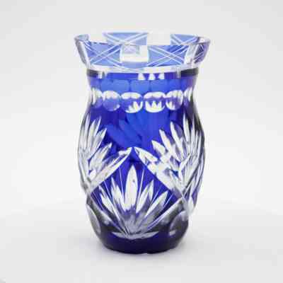 Small blue and clear cut crystal vase.: Up close image of the small blue and clear cut crystal vase decorated in a geometric Bohemian Czech-style with cobalt detail.
