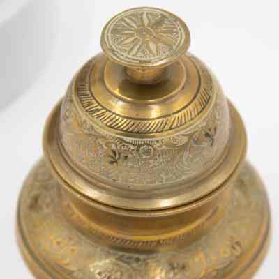 Meditation bell: The brass meditation bell showcases intricate leaf designs on its polished surface.