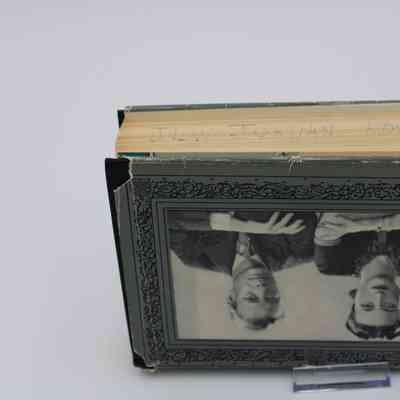 Side view of "A King's Story: The Memoirs of the Duke of Windsor": The side edge of the books pages are an aged yellow with "JLW JORDAN KOC KUWAIT" hand-written in pencil across them.