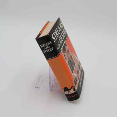 Book Spine: The spine of “Streams in the Desert” features the book title and the name of the publisher.