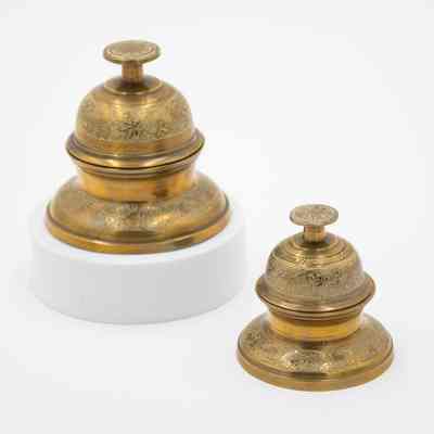 Set of brass meditation bells: The brass meditation bells feature intricate leaf designs.