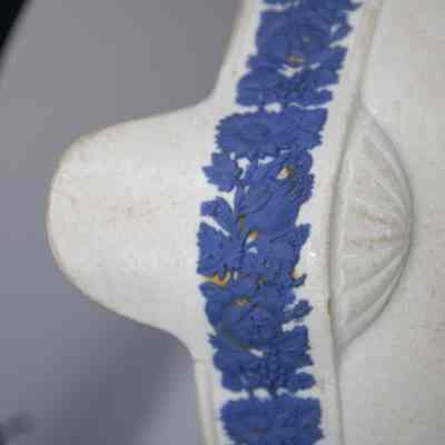 Flower rim: The image shows a white Wedgwood bowl with intricate blue floral designs adorning the rim.