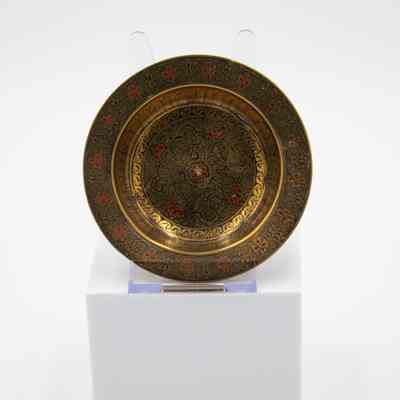 Brass ashtrays with designs: A brass ashtray features intricate black floral motifs with red accents.