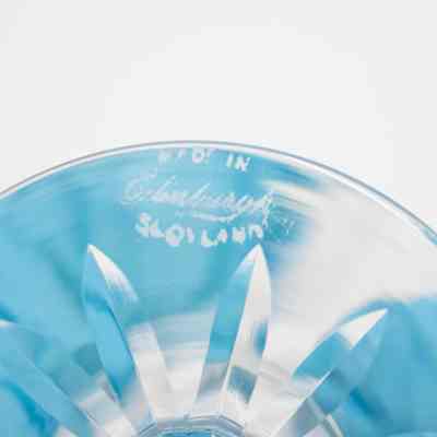 Bottom of the small cut crystal vase.: Up close image of the bottom of the small cut crystal vase. There is a small acid-etched maker's mark that reads "MADE IN Edinburgh SCOTLAND."