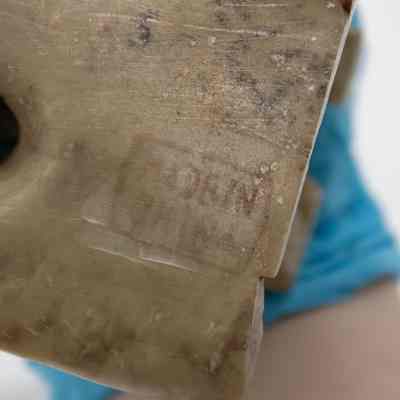 Bottom of the carved soapstone vase from China.: Up close image of the bottom of the carved soapstone vase. It is stamped with a "MADE IN CHINA" stamp.