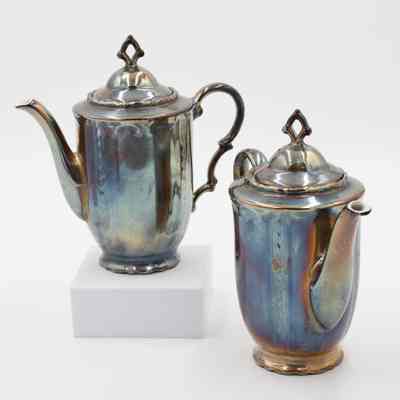 Pots: Image of a pair of silver-plated spouted pots with lids on each. The silver is tarnished.