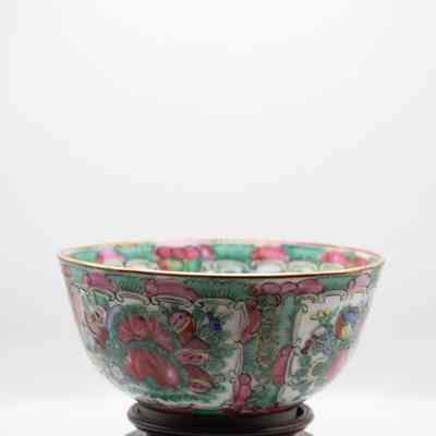 Bowl: A gold-rimmed, hand-painted Hong Kong green bowl sits on an intricately carved teakwood stand, showcasing its vibrant patterns.