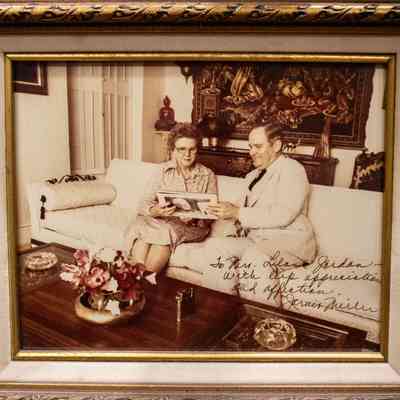 Signed Photograph of Jessie Jordan and Jarvis Miller Sitting on a White Couch
