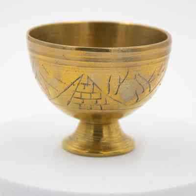Brass Egypt cups: A brass Egyptian cup features an etched pyramid design.