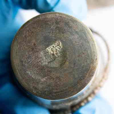 Logo on bottom of bucket: An illegible makers mark on the bottom of the silver bucket.