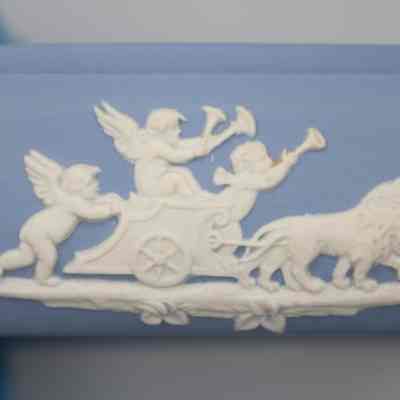 Wedgwood Jasperware square dish: The blue Wedgwood Jasperware square dish features a charming relief scene with angels, elegantly depicted in white, guiding a chariot drawn by lions.