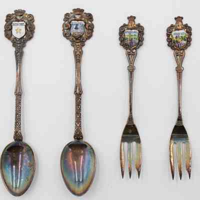 Complete set of two collector's spoons and two collector's forks from Bethlehem and Jerusalem.: Image of the set of two collector's spoons with shield of Bethlehem and forks decorated with Jerusalem. One of the spoons depicts the star of Bethlehem, which appears in the nativity story in the Bible, while the other depicts the “Christmas Bell,” which is a call to worship during Christmastime. Both forks depict scenes of Jerusalem.
