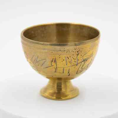 Brass Egypt cups: A brass Egyptian cup features etched pyramid designs.