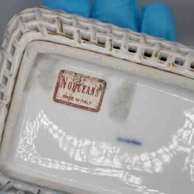 Sticker on bottom of basket: The sticker is white and red, "Noeleans; Made in Italy."