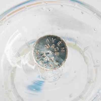 Bottom of Murano Glass vase.: Up close image of the bottom of the gold Murano Glass vase. The silver sticker reads "AVEM MADE IN ITALY MURANO" in bronze writing.
