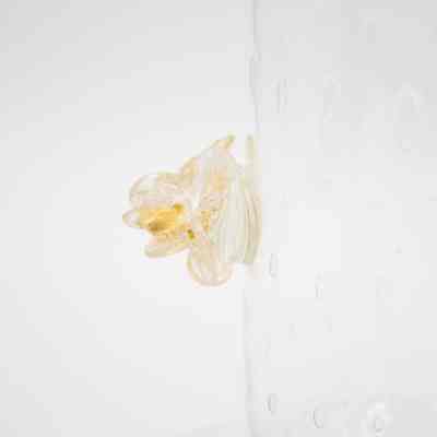 One of the handles on the Murano Glass vase.: Up close image of one of the gold glass rose-shaped handles on the Murano Glass vase.