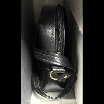 Black textured vinyl with shoulder strap.