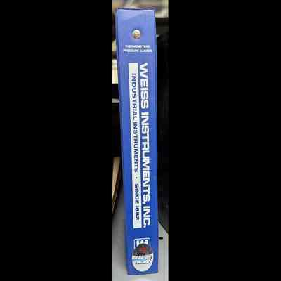3-ring binder blue in color. In white “Weiss Instruments Inc.”