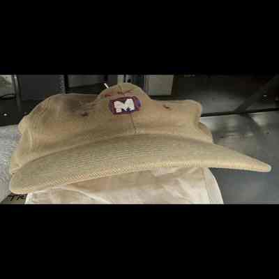 Baseball hat, tan in color, with red-and-blue Metro logo on front.