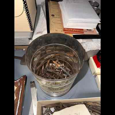 Coffee can with nails small spikes square- cut nails etc.