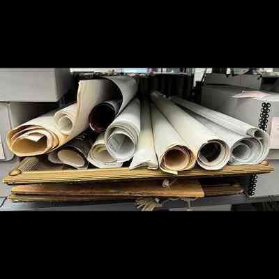Rolled drawings and framed prints.