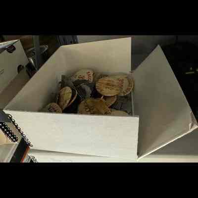 Box of round numbered baggage tag pins.