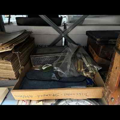 Miscellaneous artifacts in document box lid. Lid labelled “Discarded - stamped - 8/14/2014”