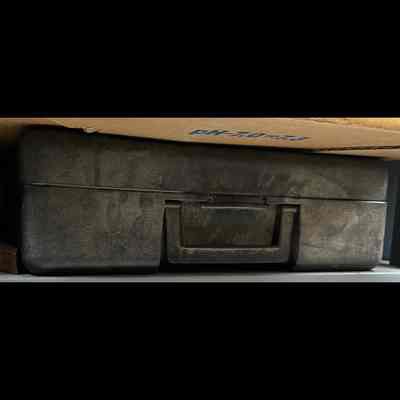 Plastic blow-molded carrying case with handle.