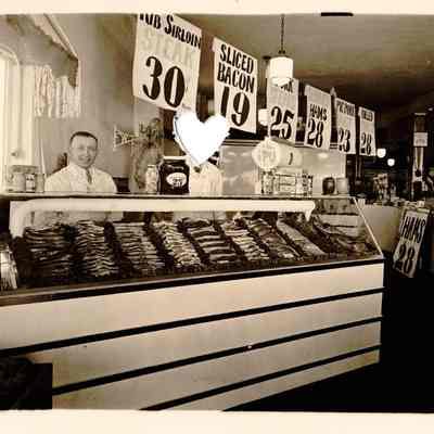 Walt Platt and Fred Scott Standing Behind Meat Counter