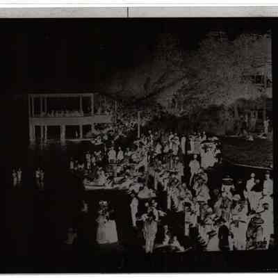 Negative of crowd of people on boardwalk