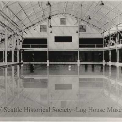 Indoor swimming pool with arched ceiling girders.