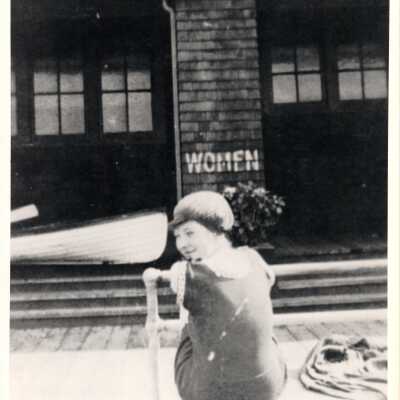 Alki Bathhouse with female swimmer posing, 1900's.