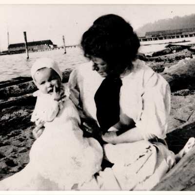 Woman with infant sitting on Alki Beach.