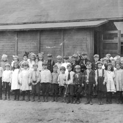 Children standing in front of building