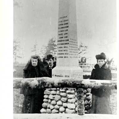 "Birthplace of Seattle" monument with 3 people