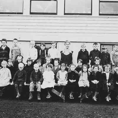 Photograph of students posed with teacher outside, Springfield, Oregon, date unknown