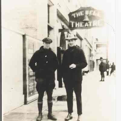 Photograph of The Bell Theater Sign & Two Men