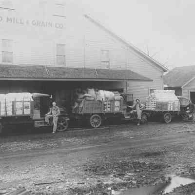 Photograph of loaded trucks at Springfield Mill & Grain Co., Oregon