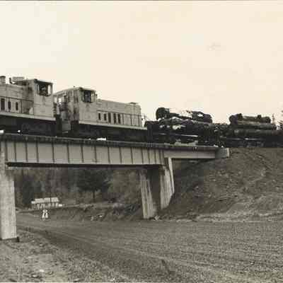Photograph of Weyerhaeuser logging train pass over Marcola road in the Upper Mabel area,