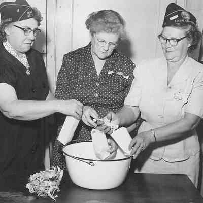 Photograph of American Legion Auxiliary members bagging popcorn, date unknown