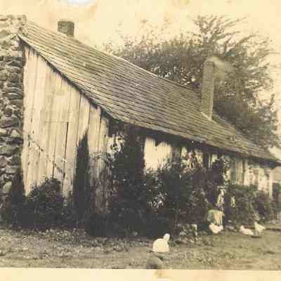 Photograph of a house with a stone chimney